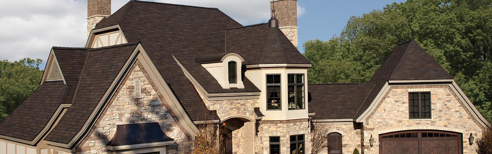 Home with a dark brown shingle roof